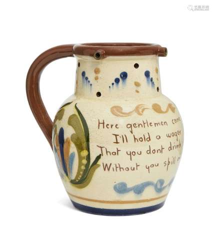 A Torquay motto puzzle jug, inscribed with the motto, Here Gentlemen come try your skill, I'll