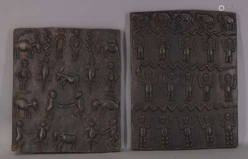 A pair of African stained half relief carved hardwood panels depicting various figures and