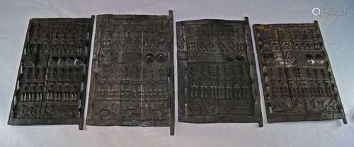 A collection of 7 Dogon half relief carved wooden door panels, each bearing door locks and