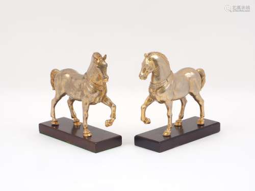 A pair of early 20th century bronze horses, after Triumphal Quadriga, each with gilt bodies to