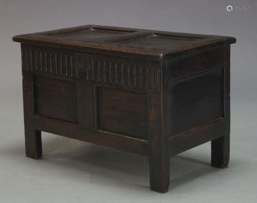 An oak coffer, 17th Century, with twin panel lid, above arcaded and conforming twin panel frieze,