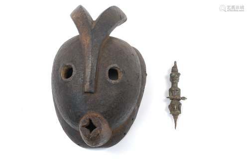 A Tribal hardwood mask, decorated with a pair of horns to the top, flanked by two round eyes and a