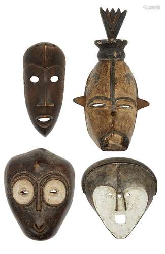 A hardwood Tribal mask, Dan, 20th century, with flaring nostrils and mouth, 25cm high, together with