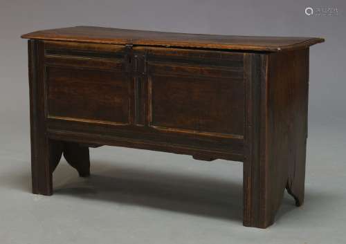 An oak coffer, 17th Century, the hinged lid enclosing candle box and storage space, with twin