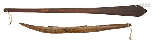 A Solomon Island paddle club, with a fine line moulding to the tip, 114cm long, together with a club