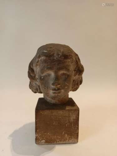 Plaster maiden's head on a square section base. \n …