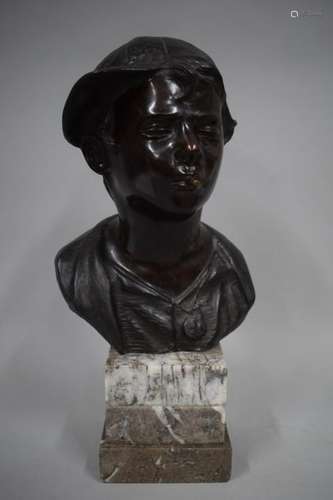 Bronze bust with black patina depicting a young bo…