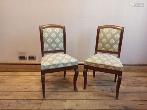 Pair of chairs covered with a green tapestry with …