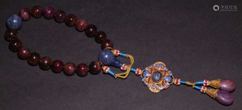A RED TOURMALINE STRING BRACELET WITH 18 BEADS
