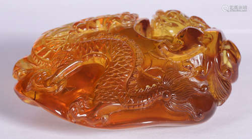 AN AMBER PENDANT CARVED WITH DRAGON