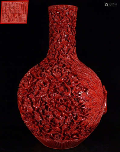 A RED GLAZE VASE CARVED WITH PEACOCK
