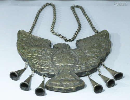 A COPPER PENDANT SHAPED WITH EAGLE