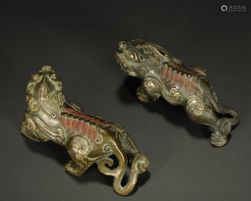 AN ARCHAIC PAIR OF BRONZE MYTHICAL BEAST