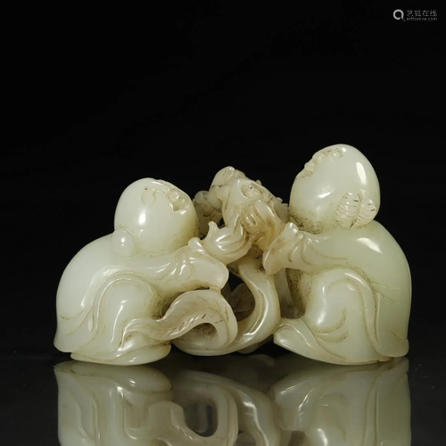 A CARVED WHITE JADE FIGURE