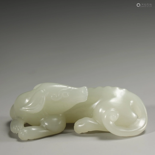 A WHITE JADE CARVING OF A MYTHICAL BE…