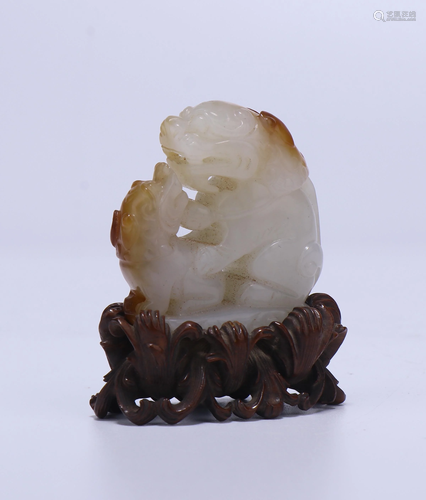 A CHINESE JADE TWO MYTHICAL BEASTS WITH ORI…