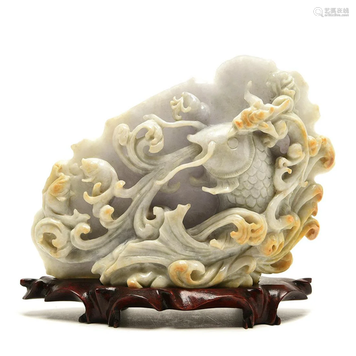 A Pale Green and Russet Jade carving of Fish and Dra…