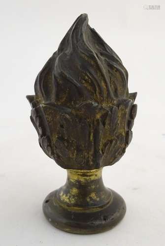 A cast bronze finial formed as a flame / torch with gilt highlights. Approx. 5 1/2