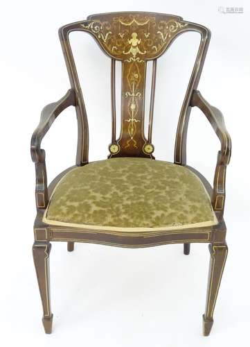 An early 20thC mahogany open armchair with marquetry decoration, decorative stringing, and a