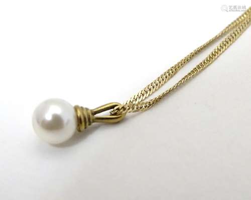 A 9ct gold chain set with yellow metal mounted pearl drop pendant. The chain 18