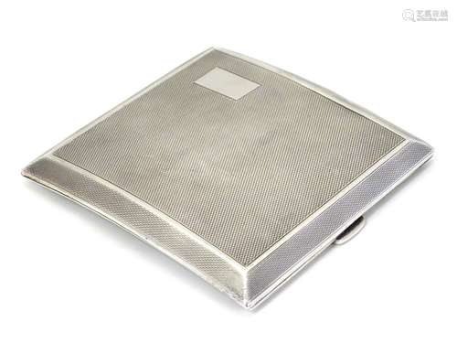 An Art Deco silver cigarette case of shaped form with engine turned decoration. Hallmarked