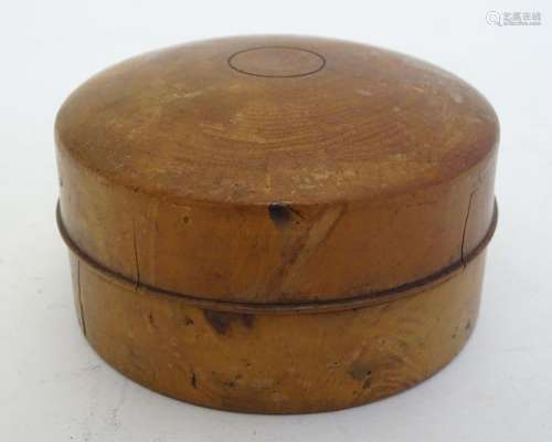 Treen: A 19thC turned wooden pot and cover of circular form, the cover with cork lining. Approx. 2