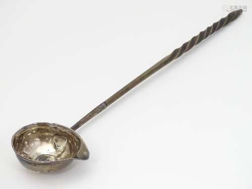 A Geo II toddy ladle with with white metal bowl inset with coin. The whole approx. 12 3/4