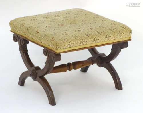 A late 19thC mahogany X-frame stool with a rectangular top, scrolled legs and a turned tapering