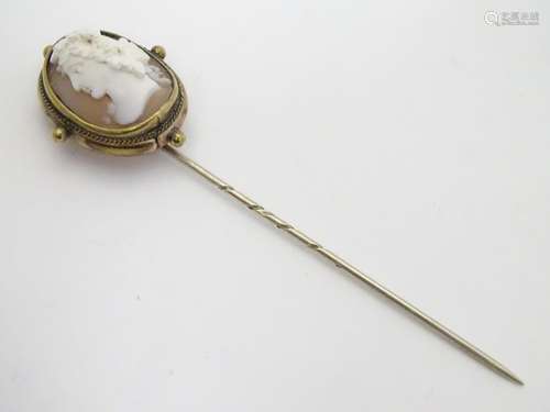 A 19thC gilt metal stick pin surmounted by a Victorian shell carved cameo depicting the head of a