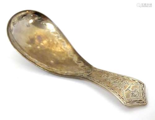 A Geo III Scottish silver caddy spoon with bright cut decoration. Approx. 3 1/2