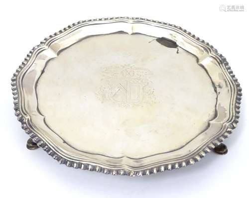 A Geo III Scottish silver waiter / salver with gadrooned border and three feet. With engraved Clan