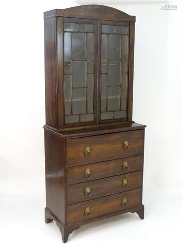 An early 19thC rosewood secretaire bookcase with an arched pediment above two astragal glazed doors,