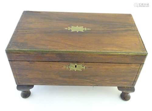 A mid 19thC rosewood writing slope with brass inlay and stringing and flanked by campaign style