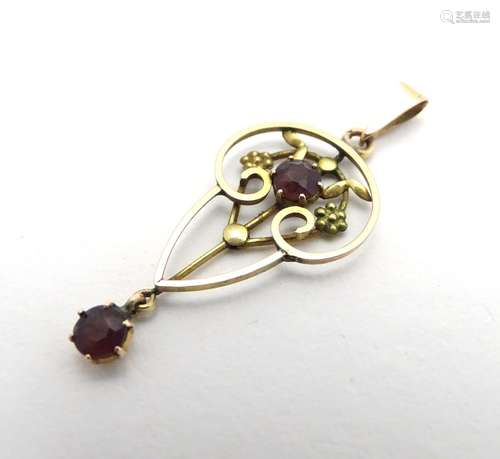 A 9ct gold Art Nouveau pendant set with amethyst stones 1 1/2