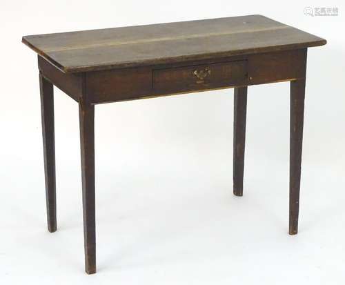 An 18thC oak side table with an overhanging top above a single short drawer and raised on tapering