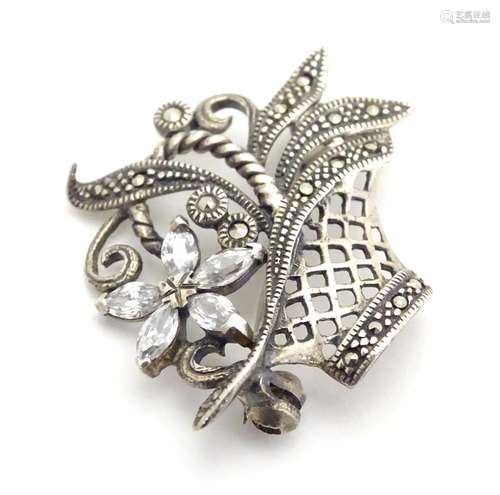 A silver brooch with marcasite and white stone detail. 1