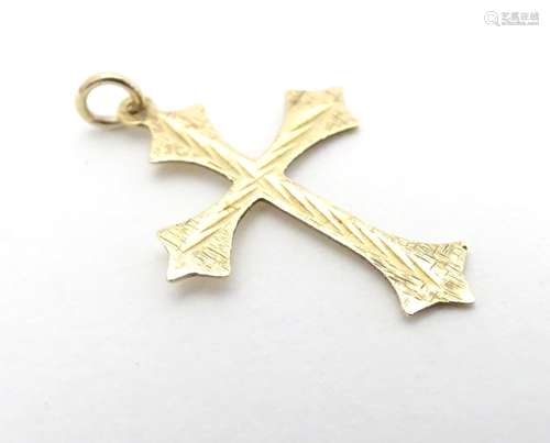 A 9ct gold pendant of cross form with engraved decoration. Approx. 1