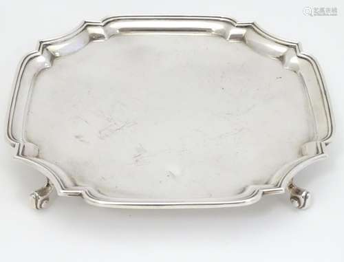 A silver waiter / card tray on four scrolling feet. Hallmarked Birmingham 1971 maker J B