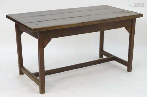 A late 18thC farmhouse table with a three plank top above a peg jointed base and supporting H