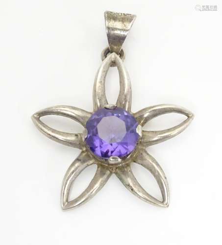 A Mexican silver pendant of floral form set with central amethyst. 1 1/2