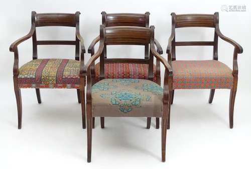 A set of four Regency mahogany carver chairs with scrolled and reeded earpieces and armrests, the