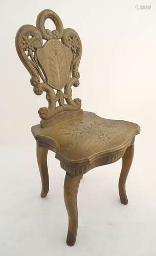 A mid 20thC music box in the form of a chair, the back rest having carved pierced decoration and