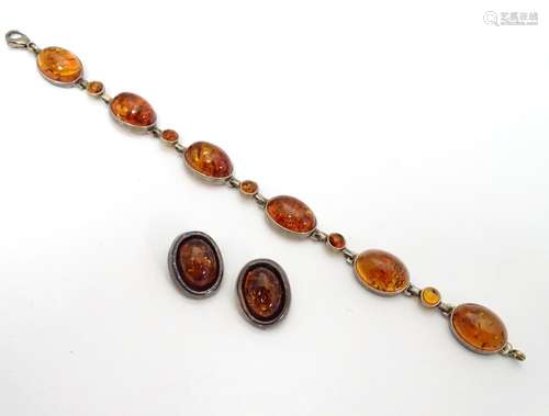 A silver bracelet set with amber cabochons together with a pair of silver clip earrings set with