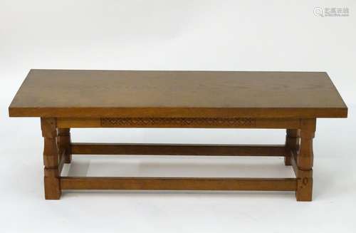 A mid 20thC oak Alan 'Acornman' Grainger coffee table, with a rectangular top above four canted