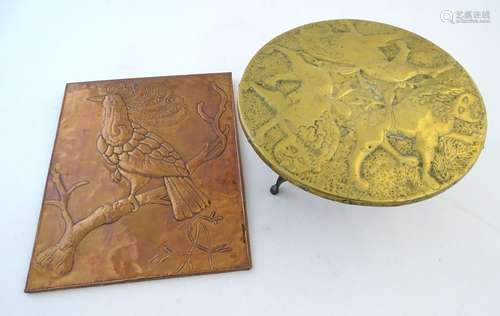 An early-20thC brass trivet, with naive decoration depicting three lions, together with a copper