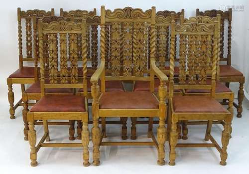 A set of twelve 19thC oak dining chairs with carved top rails, turned support and carved