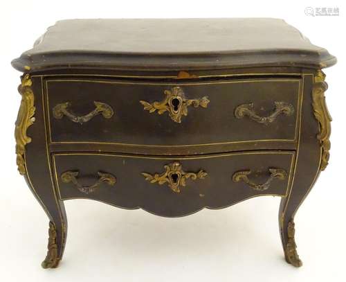 A Victorian leather covered music box formed as a bombe commode with gilt metal mounts. Approx. 9