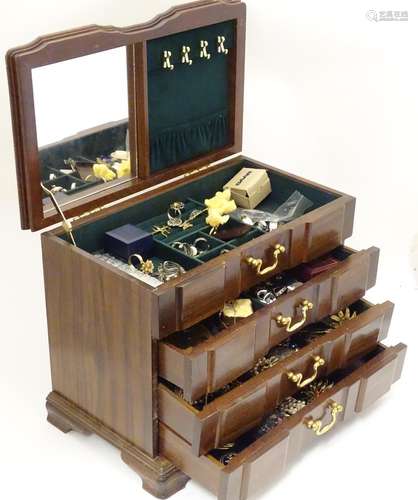 A jewellery box containing a quantity of assorted jewellery to include brooches, earrings, rings,