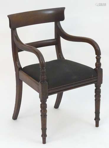 A mid 19thC mahogany open armchair with a shaped top rail and mid rail above a drop in seat and