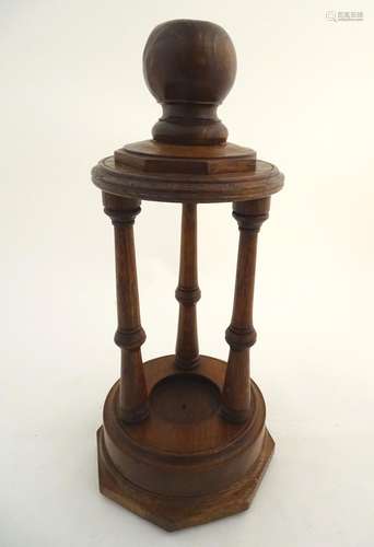 Treen: A 20thC carved wooden stand, with three columns surmounted by a knop. Approx. 20